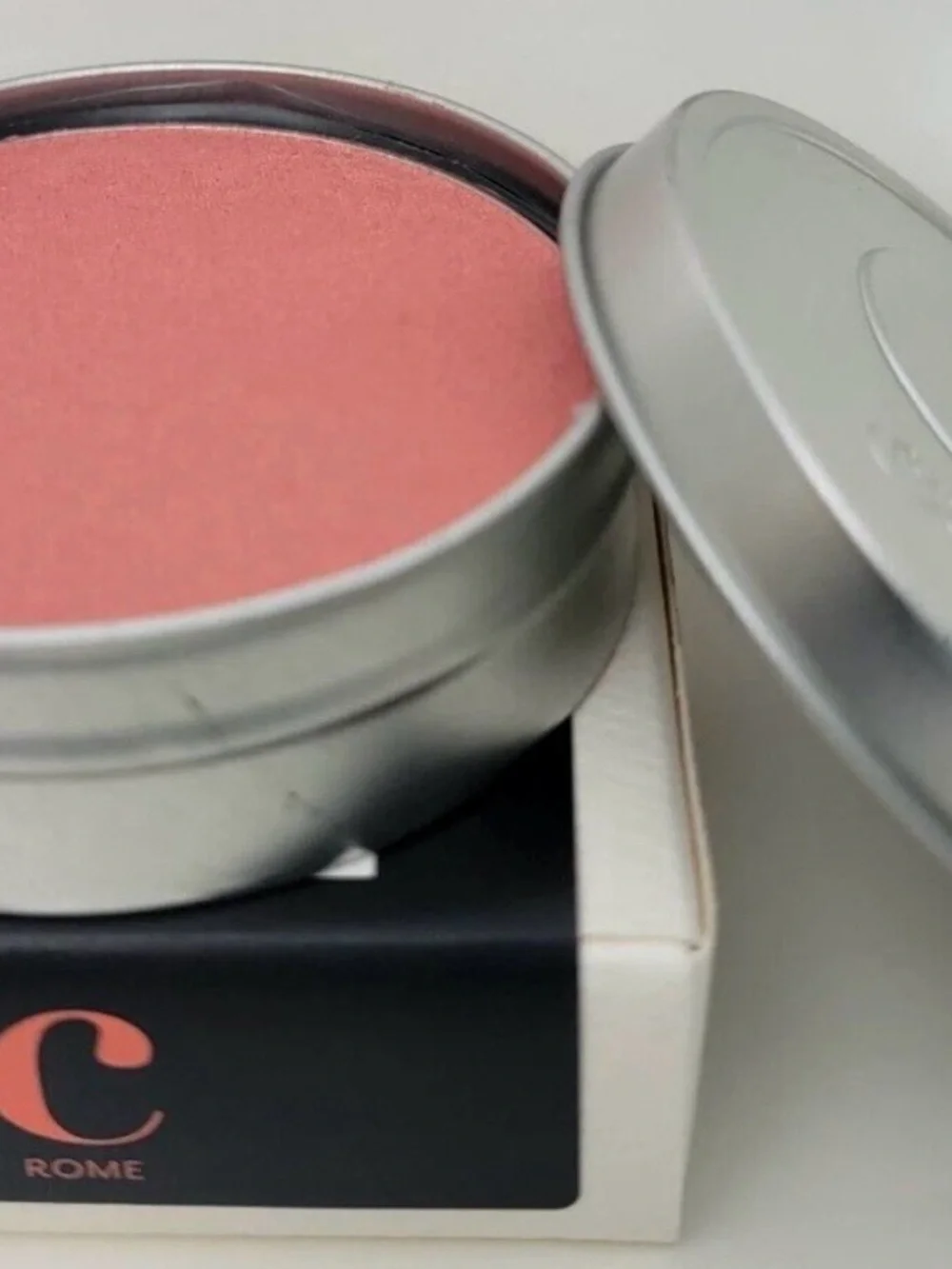 Cargo Cosmetics Powder Blush in Rome (peachy coral in color).